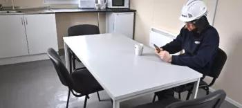 employee sat at table in modular welfare unit