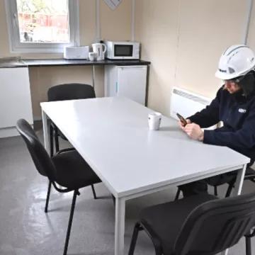 employee sat at table in modular welfare unit